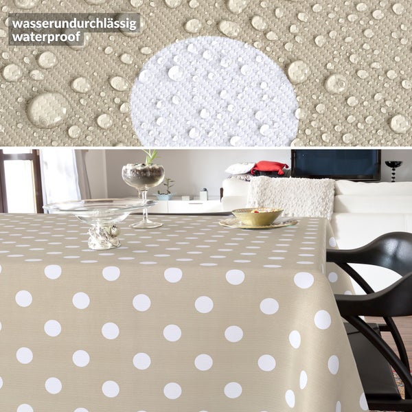 Wasserundurchlässige Tischdecke in Beige mit weißen Punkten, Detailansicht von Wassertropfen auf dem Material.