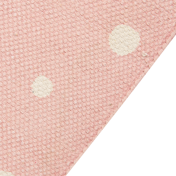 Gewebter Teppich in Rosa mit weißen Punkten und grober Struktur.
