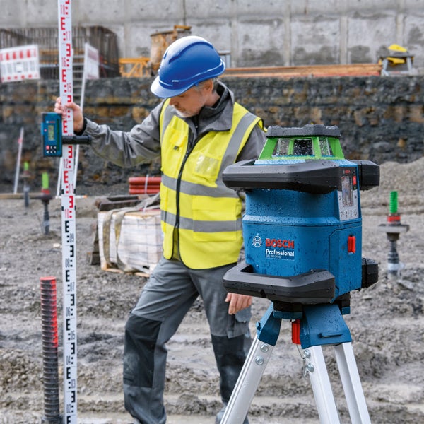 Ein Bauarbeiter benutzt einen Rotationslaser von Bosch Professional GRL 650 CHVG auf einer Baustelle.