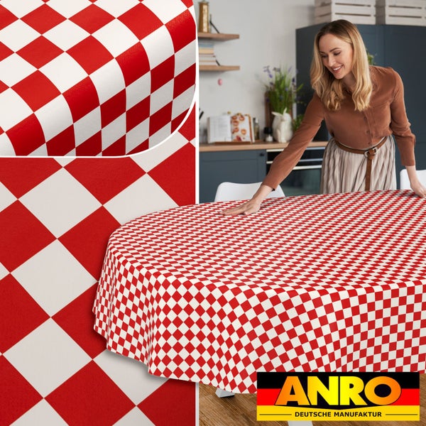 Eine Frau breitet eine rot-weiß karierte Tischdecke auf einem ovalen Tisch in einer hellen Küche aus. ANRO Logo.