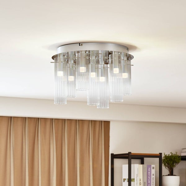 Moderne Deckenleuchte mit silberfarbener Basis und herabhängenden, geriffelten Glaszylindern in verschiedenen Längen.