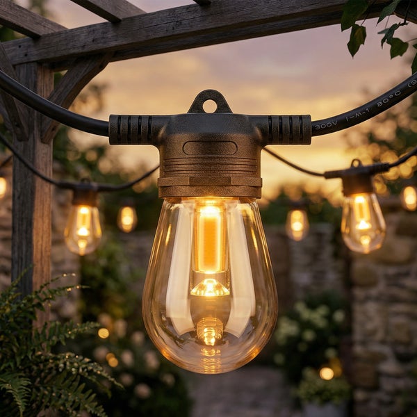 LED-Lichterkette für den Außenbereich mit warmweißen Leuchtmitteln im Edison-Design an einer Holzpergola im Garten.