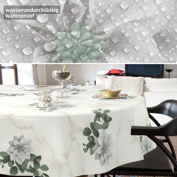 Runde, wasserundurchlässige Tischdecke mit Marmor-Optik, Weihnachtsstern-Motiven und grünen Blättern in einem Wohnzimmer.