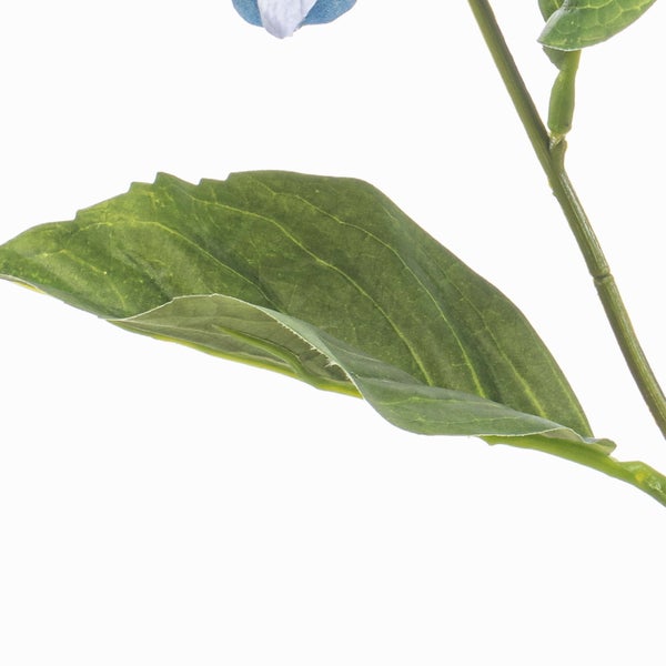 Detailansicht eines künstlichen Pflanzenstiels mit einem grünen Blatt.