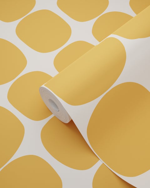 Vliestapete mit großen gelben abgerundeten Formen auf weißem Hintergrund, teilweise aufgerollt.