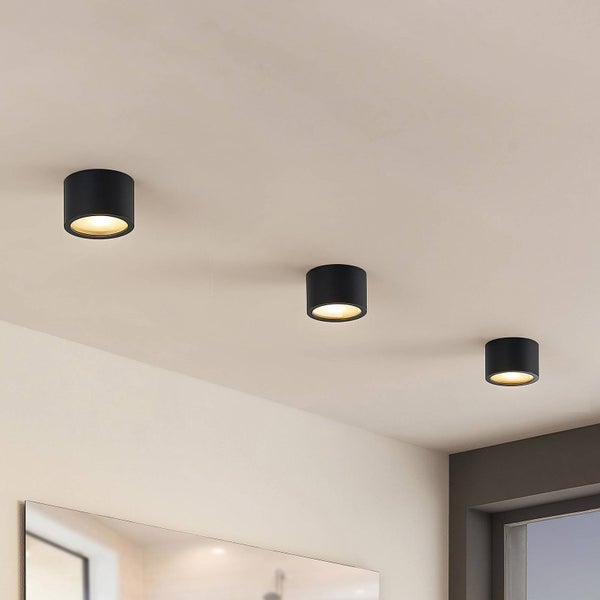 Drei zylindrische Deckenleuchten in einem hellen Raum