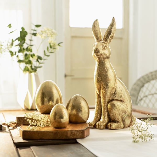 Dekorativer goldfarbener Hase als Osterdekoration