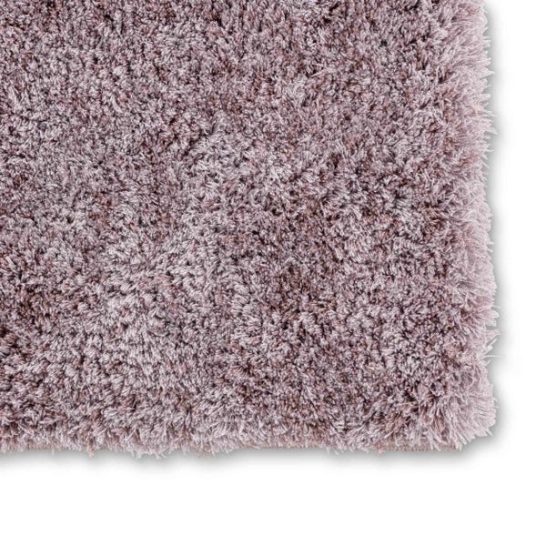 Zottelige Badematte mit hohem Flor und weicher Textur, Detailansicht von Kante und Ecke.