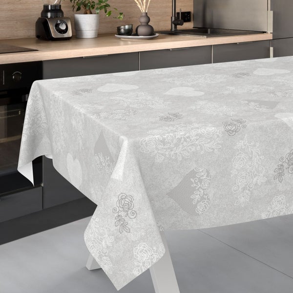 Wachstuch-Tischdecke mit floralem Rosenmuster und Herzen auf einem Tisch in einer modernen Küche.