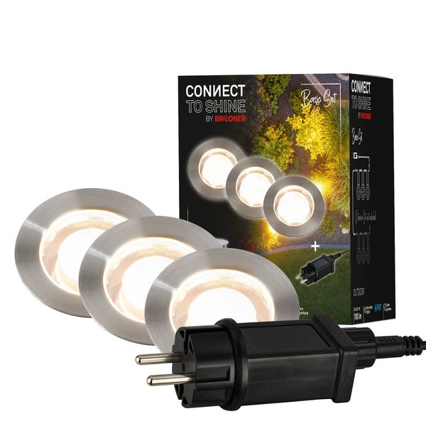 Briloner Connect to Shine Basis Set mit drei LED Garten Einbaustrahlern in Silber mit warmweißem Licht und einem schwarzen Netzstecker.