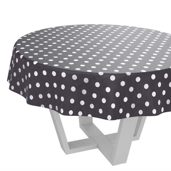 Runde Tischdecke mit Pünktchenmuster auf einem Tisch.