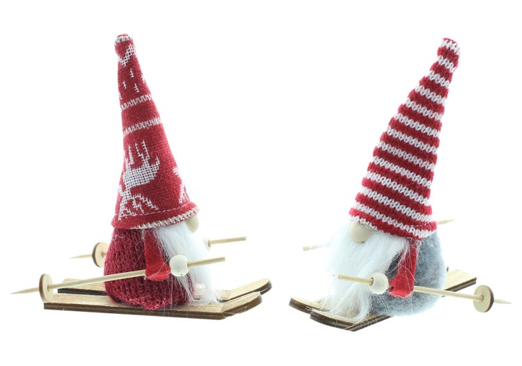 Zwei weihnachtliche Zwerge auf Skiern als Dekoration