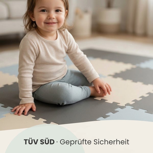 Kleinkind sitzt auf einer TÜV SÜD geprüften Puzzlematte aus Schaumstoff in einem hellen Raum.