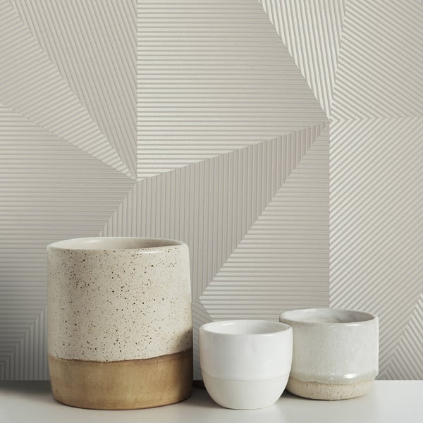 Dekorative Wand mit geometrischem Muster und drei Vasen