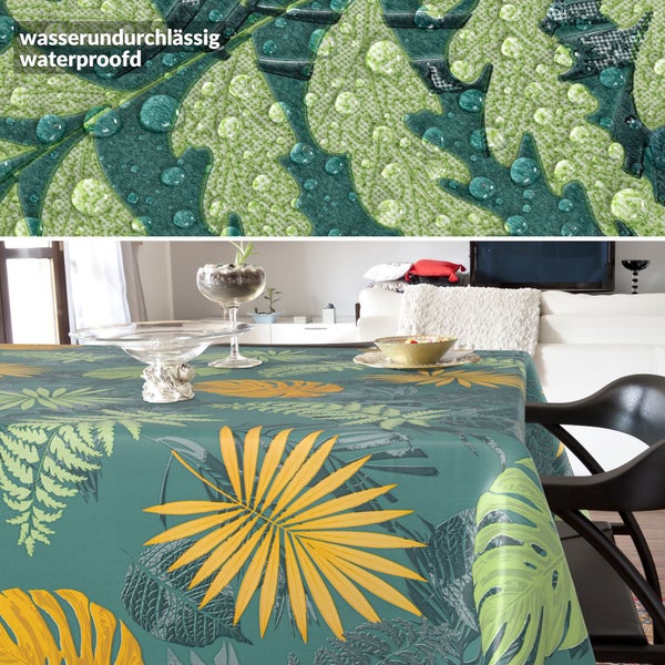 Wasserundurchlässige Tischdecke mit botanischem Blattmuster auf einem Tisch, Detailansicht zeigt Wassertropfen auf der Oberfläche.