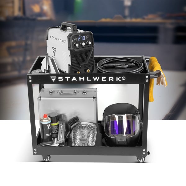 Organisierter schwarzer Stahlwerk Schweißwagen mit zwei Etagen. Oben Schweißgerät und Kabel, unten Werkzeugkoffer, Schweißhelm und Werkzeuge.