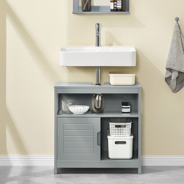 Badezimmerwaschtisch mit Waschbecken, Armatur und Stauraumlösung.