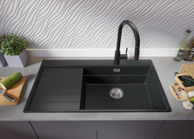 Spüle mit Abtropffläche und Armatur auf einer Arbeitsplatte in der Küche