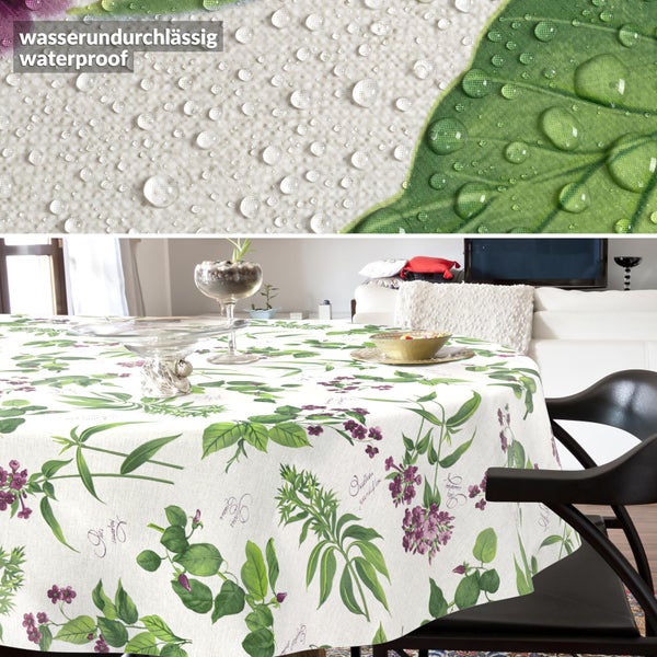 Wasserundurchlässige Tischdecke mit floralem Muster auf einem runden Tisch. Detailansicht der wasserabweisenden Oberfläche mit Wassertropfen.
