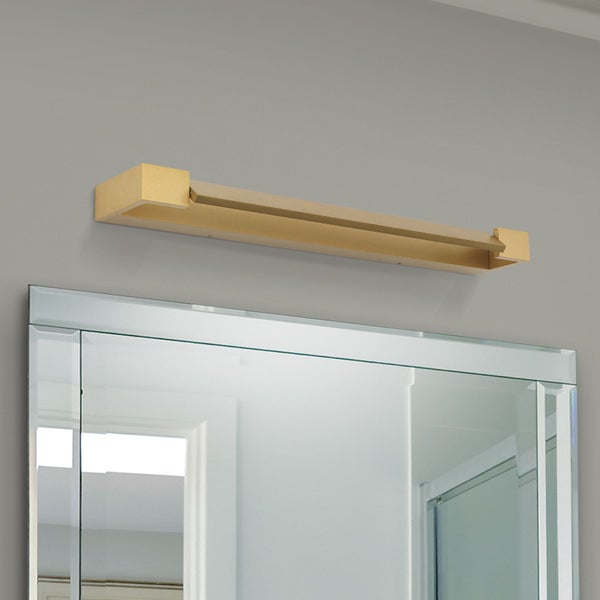 Moderne LED Spiegelleuchte in minimalistischer Form an einer Wand über einem Spiegel montiert.