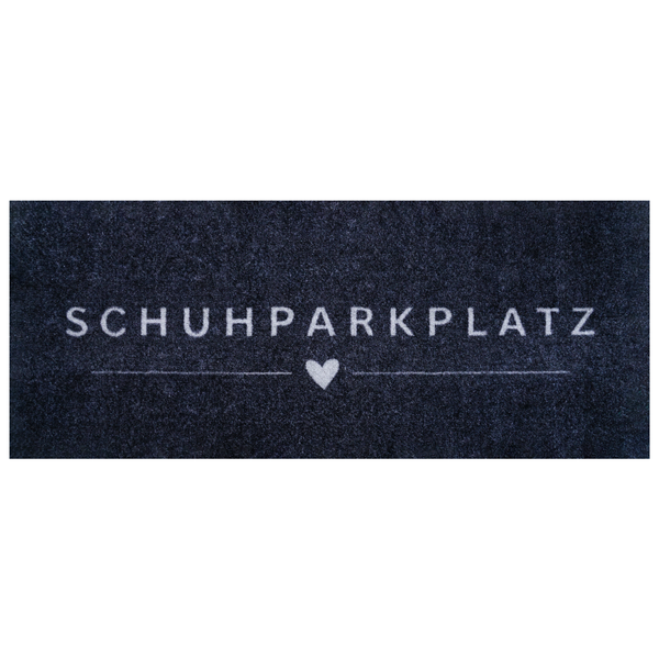 Fußmatte mit dem Schriftzug SCHUHPARKPLATZ und einem Herzsymbol.