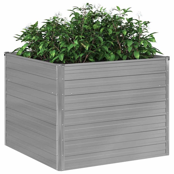 Quadratisches Hochbeet aus Metall, bepflanzt mit grünen Sträuchern und kleinen weißen Blüten.
