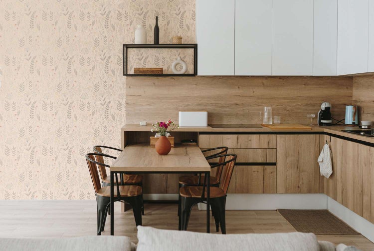 Moderne Küche mit integriertem Essbereich und floraler Tapete in einem hellen und gemütlichen Wohnraum mit Holzelementen.