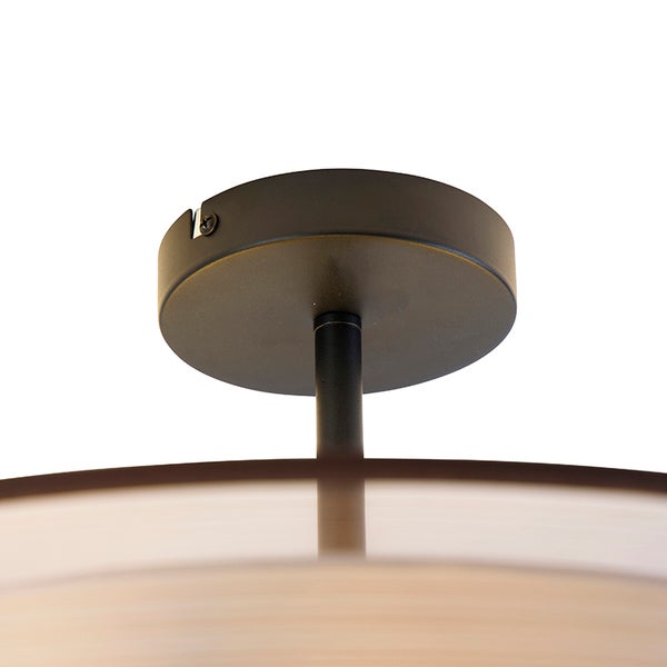 Runder Deckenbaldachin aus schwarzem Metall für eine Leuchte.