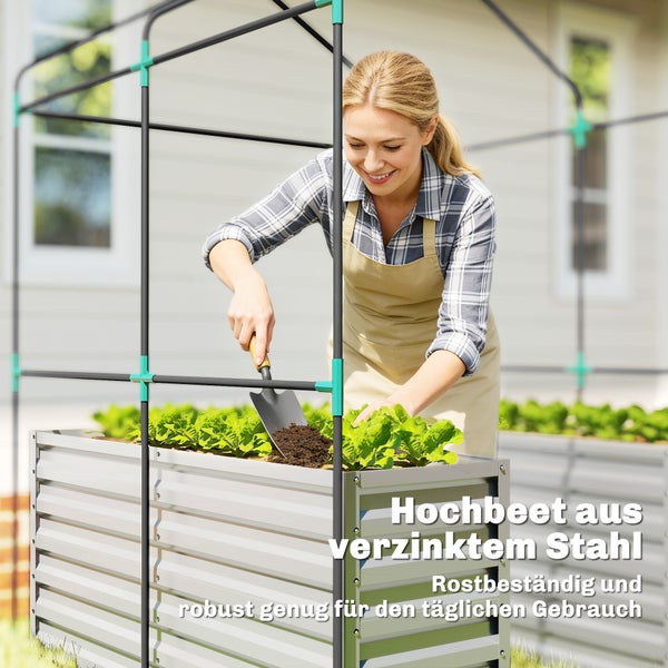 Eine Person arbeitet mit einer Schaufel in einem Hochbeet aus verzinktem Stahl mit einem stabilen Rahmen für eine Abdeckung.