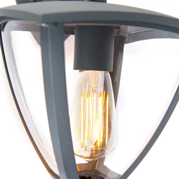 Schwarze Außenwandleuchte mit Glaseinsätzen und einer brennenden LED-Filamentlampe.