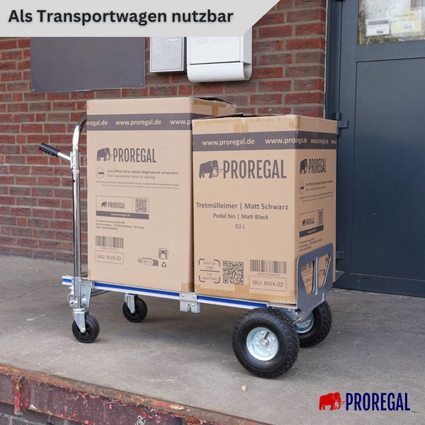 Proregal Transportwagen mit zwei großen Luftreifen und zwei Lenkrollen, beladen mit zwei großen Kartons vor einer Ziegelwand.