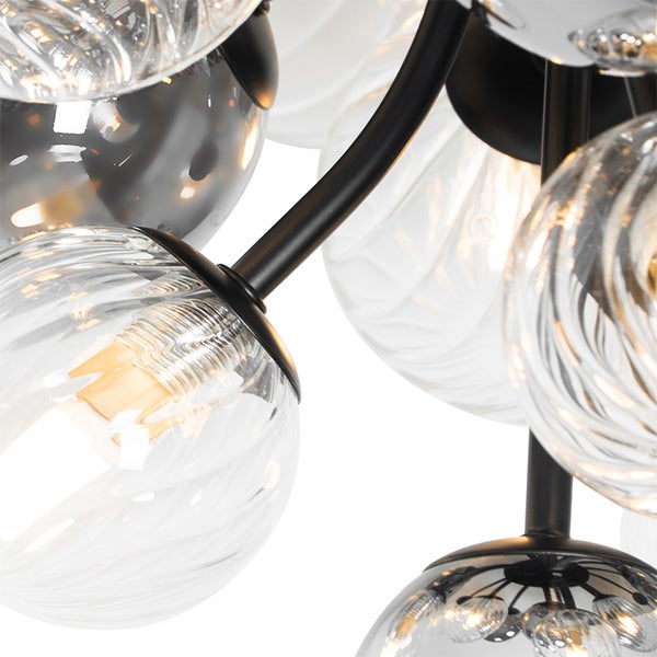 Nahaufnahme einer Pendelleuchte mit Glaskugeln und schwarzem Gestell