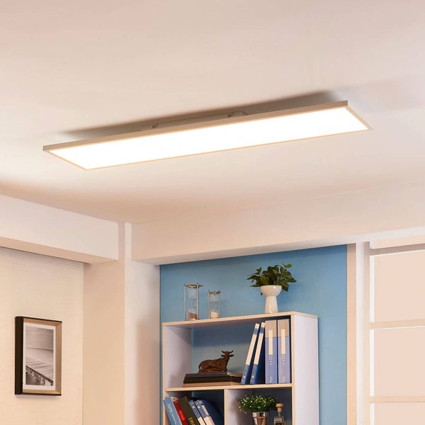 Flaches, rechteckiges LED-Panel an der Decke in einem hellen Raum mit einem Bücherregal.