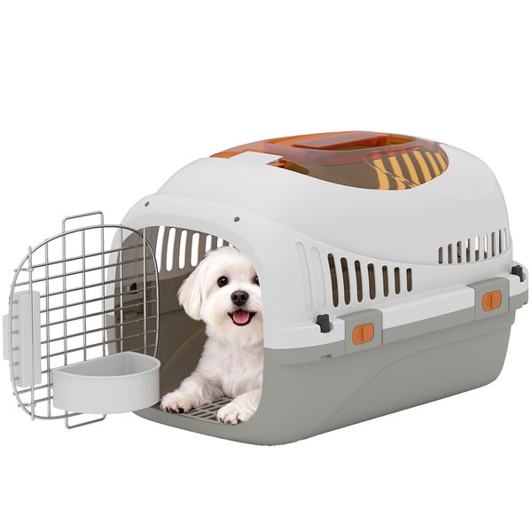 Kunststoff-Transportbox für Hunde und Katzen mit Metallgittertür und einem kleinen weißen Hund im Inneren.