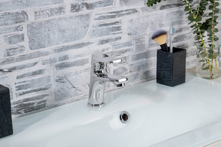 Modernes Badezimmer mit Waschbecken, Armatur und dekorativen Elementen