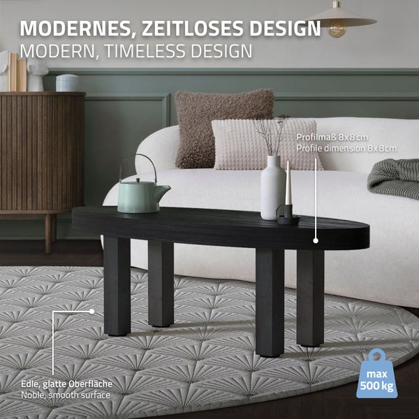 Moderner Couchtisch aus dunklem Holz im hellen Wohnzimmer auf einem Teppich mit einer Tragkraft von maximal 500 Kilogramm.