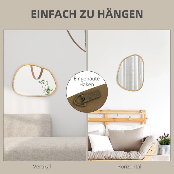 Dekorativer Spiegel mit Holzrahmen hängt an der Wand über einem Nachttisch mit Dekoration.