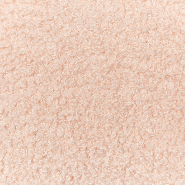 Nahaufnahme der weichen Textur eines Bouclé-Stoffs.