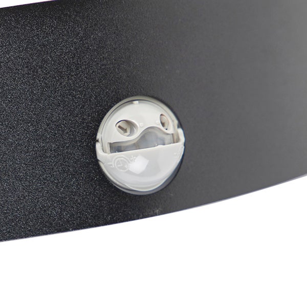 Detailaufnahme eines Bewegungsmelders, der in ein schwarzes Metallgehäuse integriert ist.