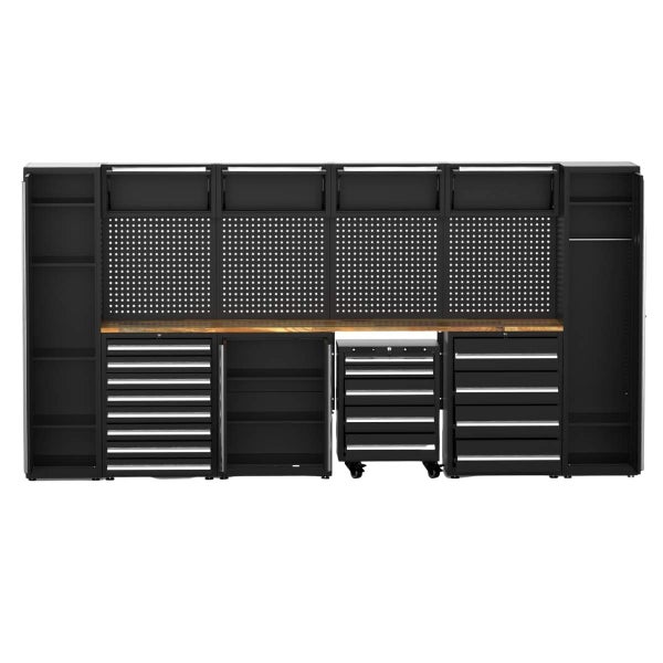 Modulares Werkstattwandsystem mit Werkbank aus Holz, Lochwänden, Schubladenelementen und Schränken für organisierte Werkzeugaufbewahrung.