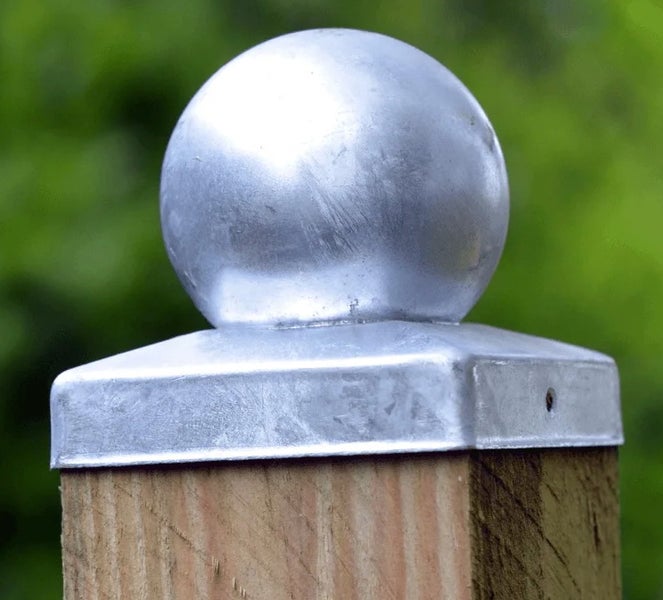 Metallpfostenkappe mit Kugel auf einem Holzpfosten