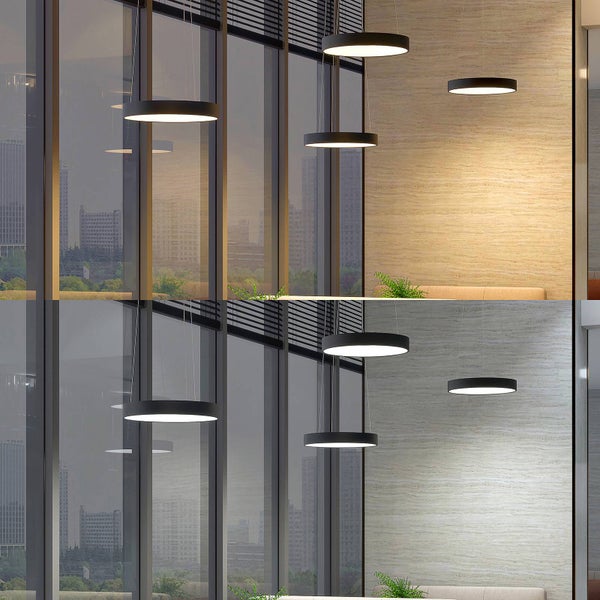 Schwarze ringförmige LED-Pendelleuchten in modernem Raum mit Glasfassade, dargestellt in warmweißem und kaltweißem Licht.