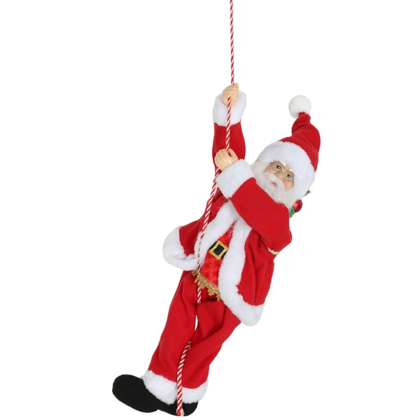 Weihnachtsmann-Figur kletternd an einem rot-weiß gestreiften Seil.