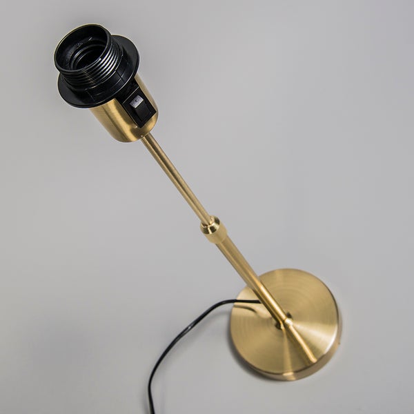 Goldfarbene Tischleuchte mit schwarzer Fassung und Schalter