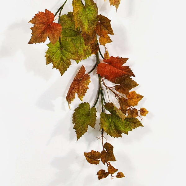Künstliche Lilien mit weißen Blüten, roten Sprenkeln und grünen Blättern.
