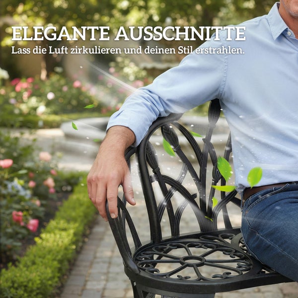 Gartenstuhl aus Metall mit ornamentalen Ausschnitten für Luftzirkulation in einem blühenden Garten mit einer sitzenden Person.