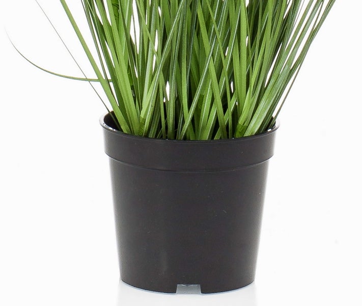 Künstliches Gras in einem schwarzen Kunststofftopf.
