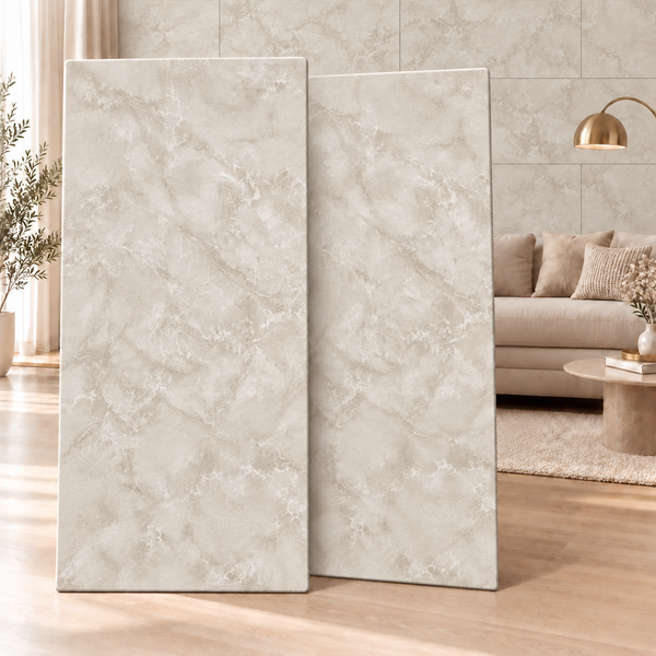 Zwei große Wandfliesen mit Marmoroptik vor einem elegant eingerichteten Wohnzimmer.
