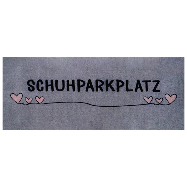 Rechteckige Fußmatte mit der Aufschrift SCHUHPARKPLATZ und dekorativen Herzen
