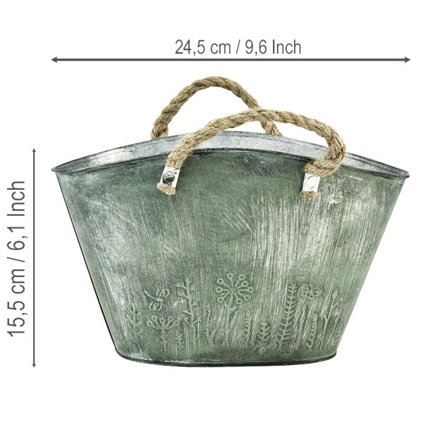 Ovaler Metall-Pflanzkübel mit Seilgriffen und Blumenmuster, Maße 24,5 Zentimeter Breite und 15,5 Zentimeter Höhe.